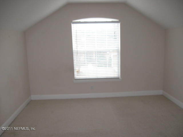 4583 Reed Bark Lane Jacksonville, FL 32246 - Photo 4 of 5 an empty room with a window