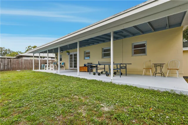 a view of a porch with chairs and backyard