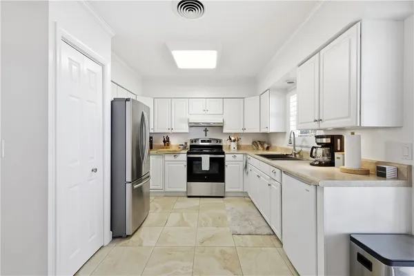 a kitchen with stainless steel appliances granite countertop a refrigerator sink and cabinets