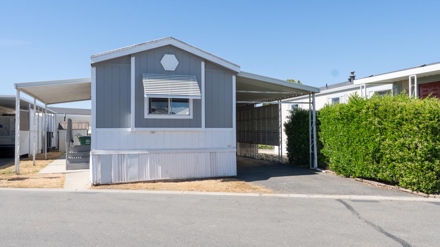 1400 Meredith Avenue, Unit 95 Gustine, CA 95322 - Photo 1 of 1 a front view of a house with a yard