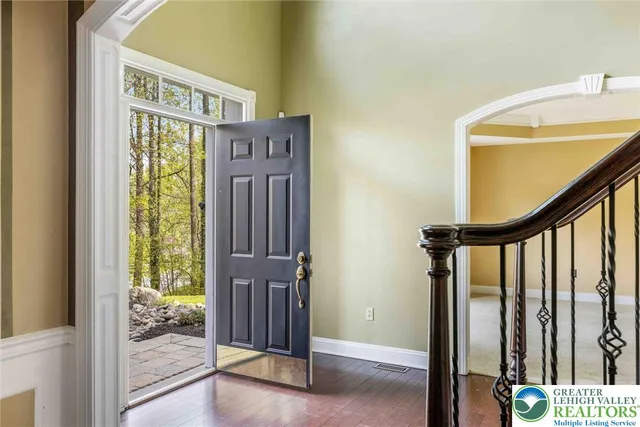a view of entryway with wooden floor and stairs