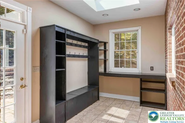 an empty room with windows and fireplace