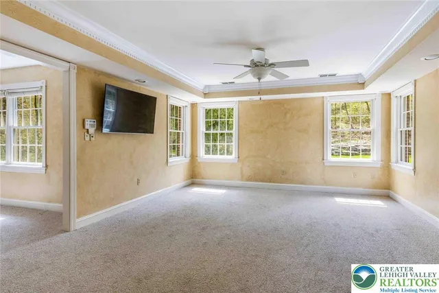 a view of a livingroom with a ceiling fan and window