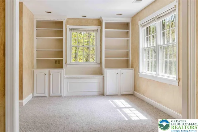 a spacious bathroom with a tub sink and mirror