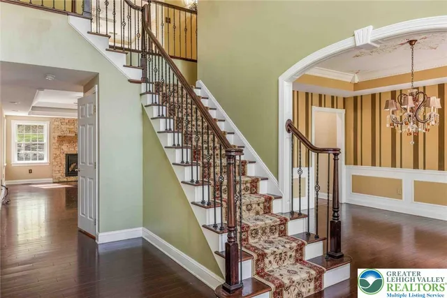 a view of a hallway with wooden floor and windows