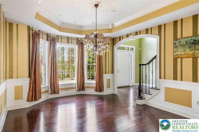 a view of a hallway with wooden floor and entryway