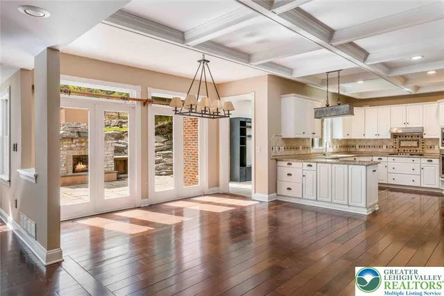 a view of a dining room with furniture wooden floor and chandelier