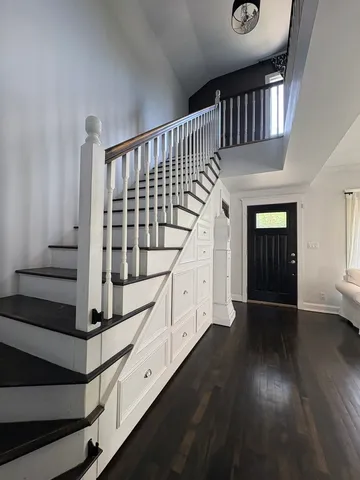 a view of entryway with stairs and wooden floor