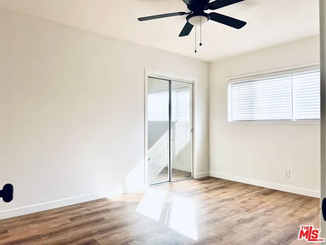 a view of a livingroom with a ceiling fan and window