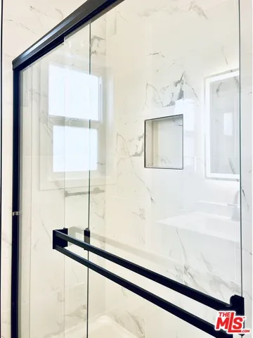 a bathroom with a bathtub and a shower