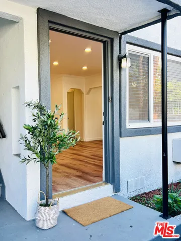 a vase of flowers sitting on a table next to a window