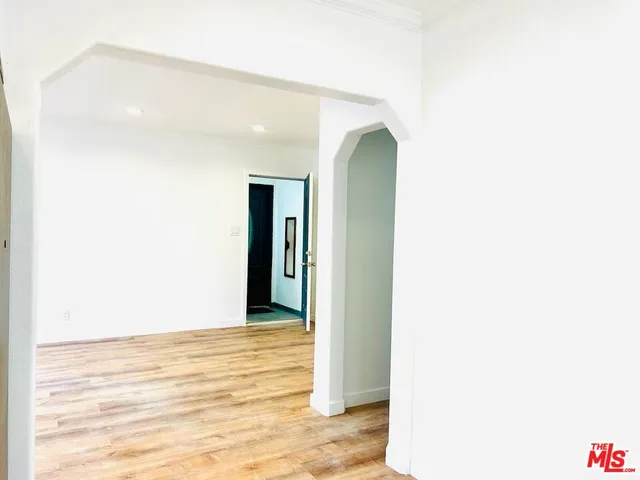 a view of a room with wooden floor