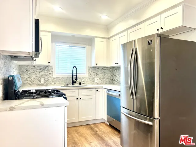 a kitchen with a refrigerator and a sink