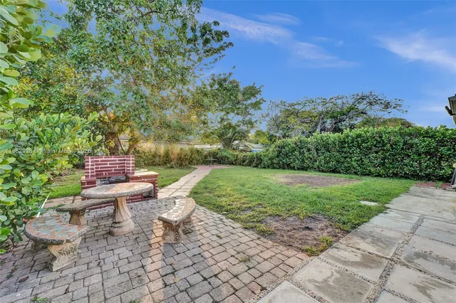 a view of a chair and table in the garden