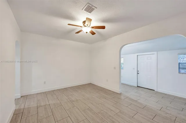 a kitchen with stainless steel appliances granite countertop a refrigerator a sink dishwasher a stove and white cabinets