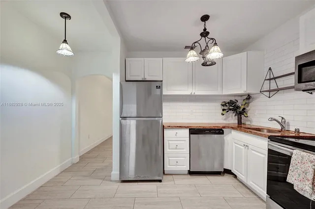 a kitchen with a refrigerator and a sink