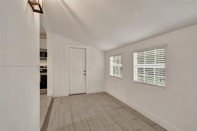 a bathroom with a granite countertop sink a toilet a mirror and shower