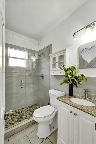 a bathroom with a toilet a sink and bathtub