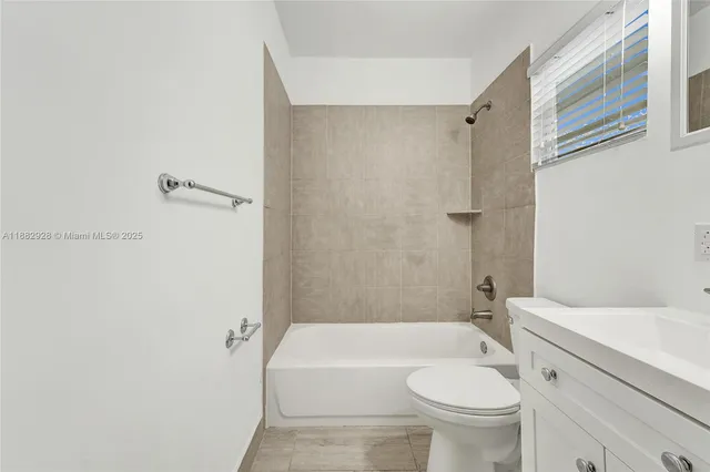 a bathroom with a toilet a sink and bathtub