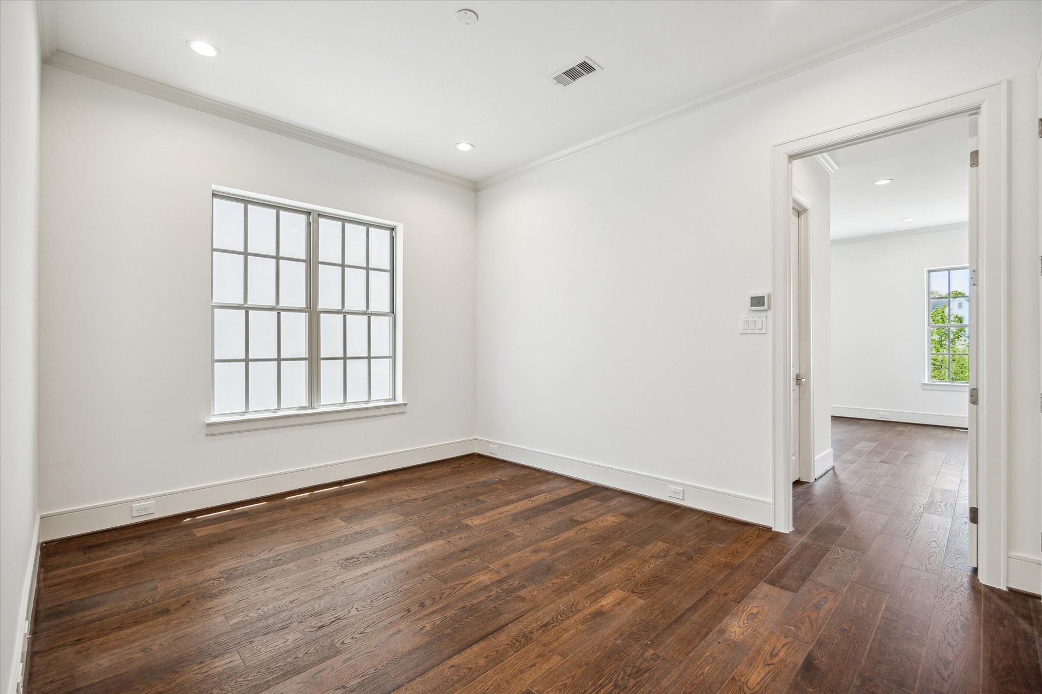 209 Sutton Row Place Houston, TX 77024 - Photo 11 of 23 Sitting room off second floor stairwell landing, access to primary bedroom on right and utility room and secondary bedroom/bath on left.