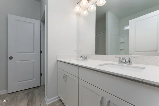 a bathroom with a double vanity sink and a mirror
