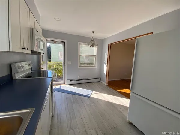 a view of a refrigerator in kitchen and livingroom with furniture