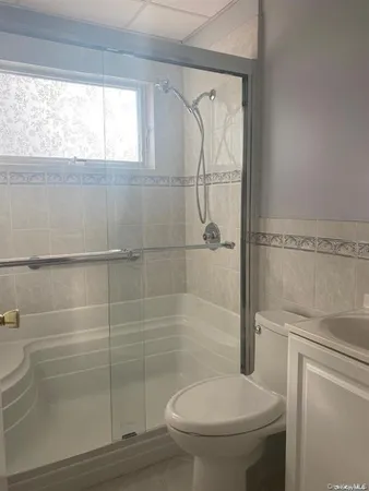 a bathroom with a toilet and a shower