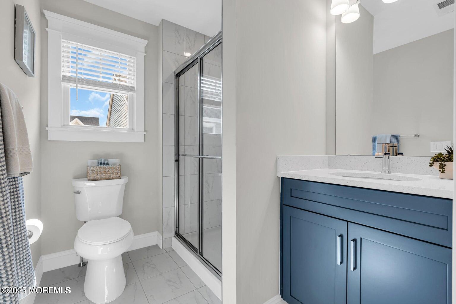 6 Shell Road Mantoloking, NJ 08738 - Photo 15 of 54 a bathroom with a toilet a sink and mirror