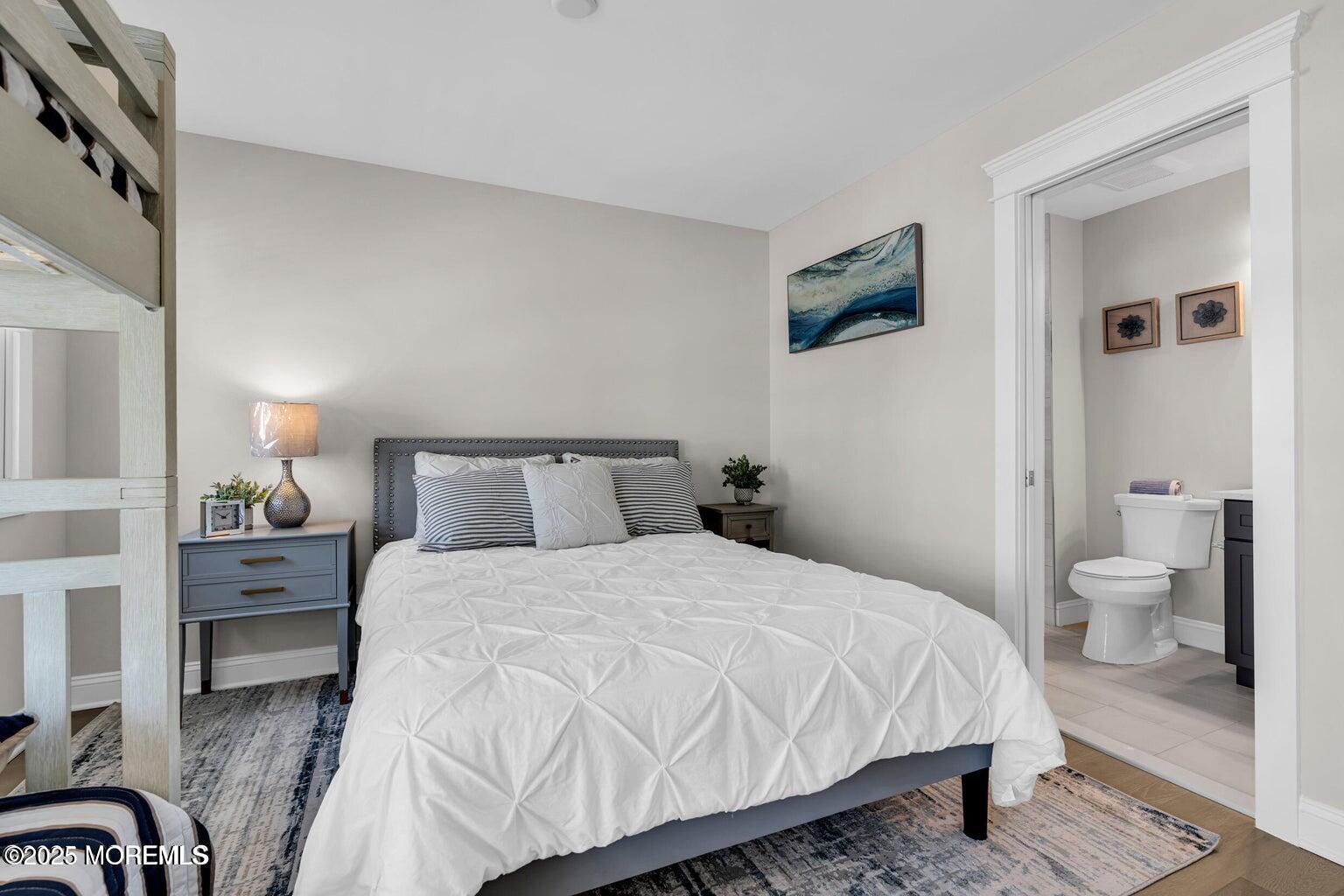 6 Shell Road Mantoloking, NJ 08738 - Photo 20 of 54 a bedroom with a bed and a view of bathroom