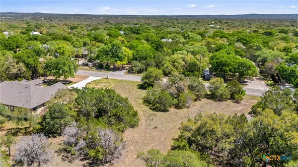 an aerial view of a houses with a yard
