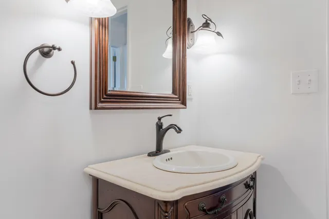 a bathroom with a sink and a mirror