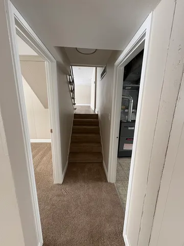 a view of a hallway with stairs