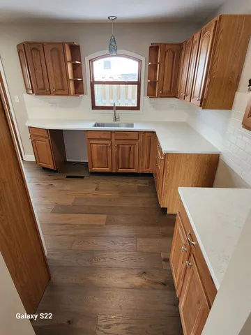 a kitchen with stainless steel appliances granite countertop a sink and a stove