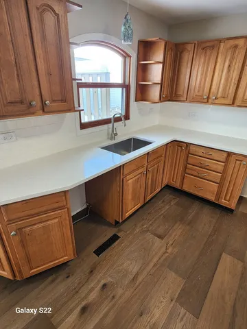 a kitchen with stainless steel appliances granite countertop a sink dishwasher stove and cabinets