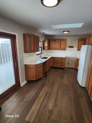 a large bathroom with a tub a sink and a large mirror
