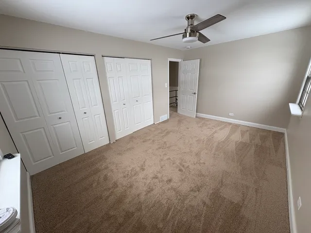 a view of a livingroom with a chandelier fan