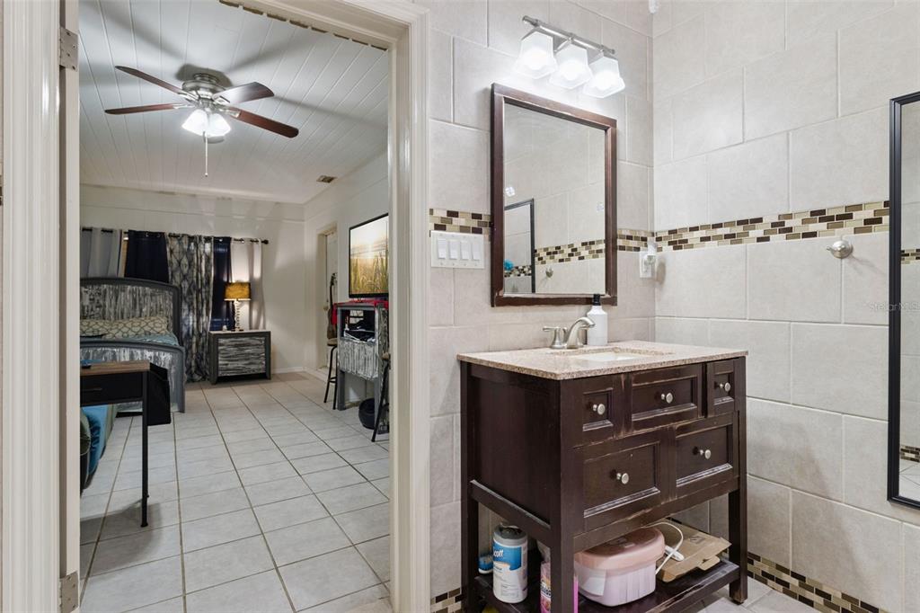 303 Granada Road Auburndale, FL 33823 - Photo 11 of 25 a bathroom with a sink a mirror and a shower