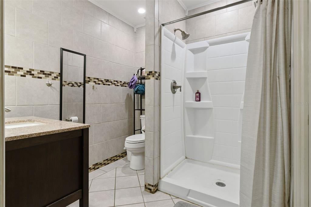 303 Granada Road Auburndale, FL 33823 - Photo 12 of 25 a bathroom with a shower a toilet and sink