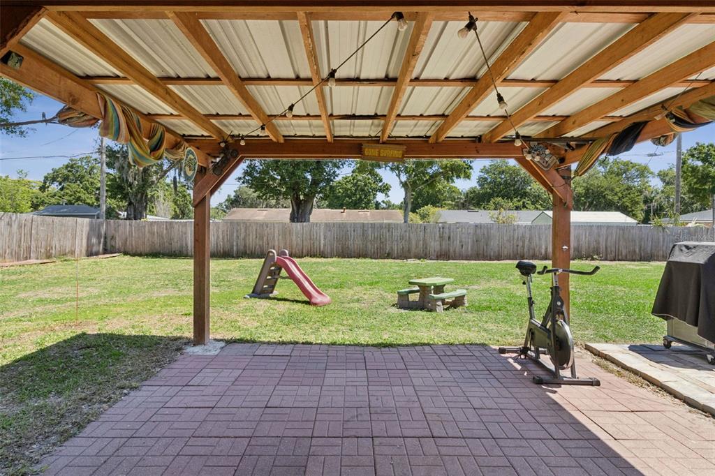 303 Granada Road Auburndale, FL 33823 - Photo 17 of 25 a view of yard with swimming pool and garden