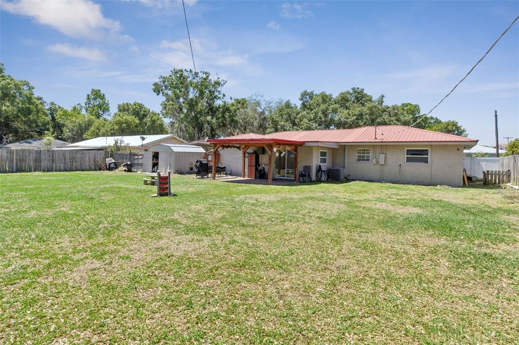 303 Granada Road Auburndale, FL 33823 - Photo 19 of 25 a view of a house with a yard and sitting area