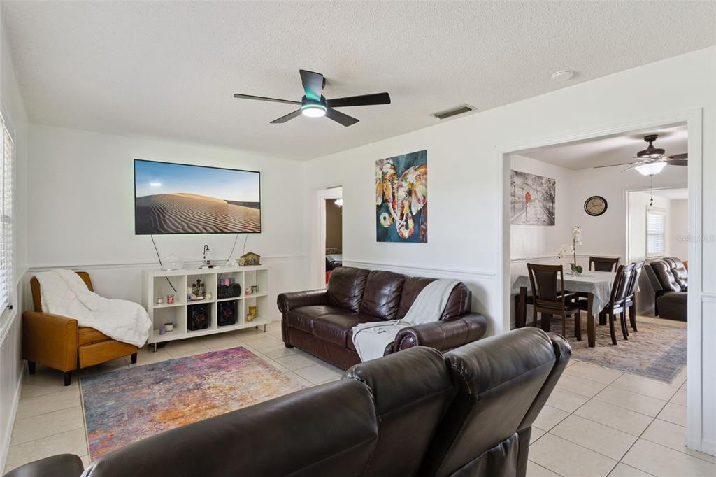 303 Granada Road Auburndale, FL 33823 - Photo 3 of 25 a living room with furniture and a flat screen tv