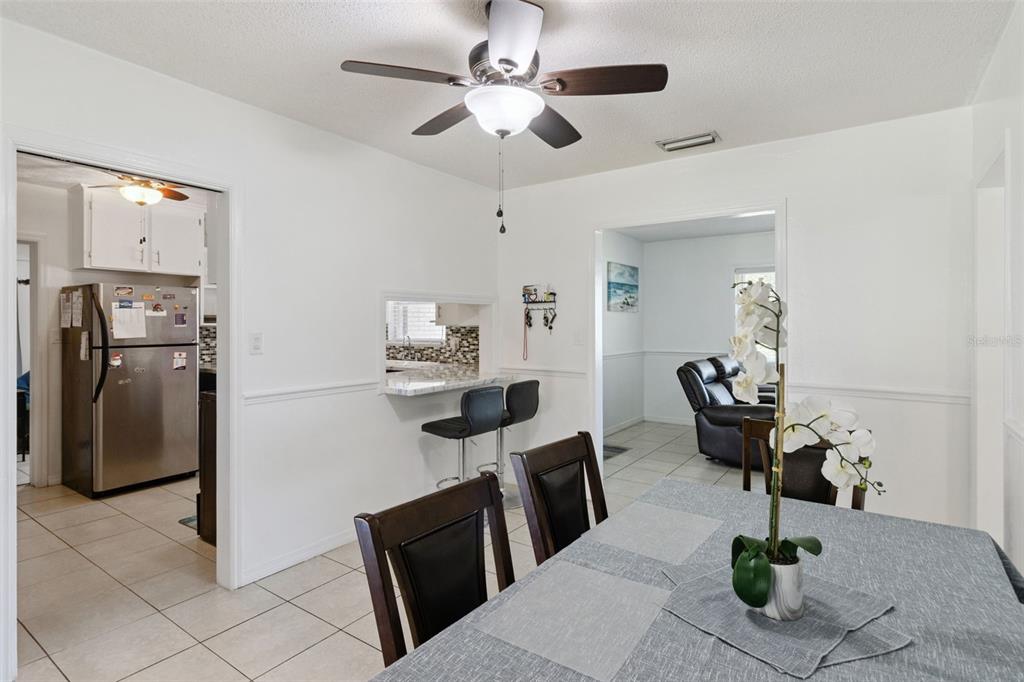 303 Granada Road Auburndale, FL 33823 - Photo 5 of 25 a living room with furniture a dining table and chairs