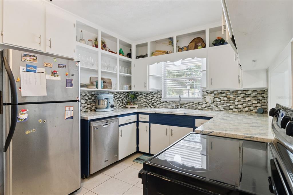 303 Granada Road Auburndale, FL 33823 - Photo 6 of 25 a kitchen with a refrigerator and a sink