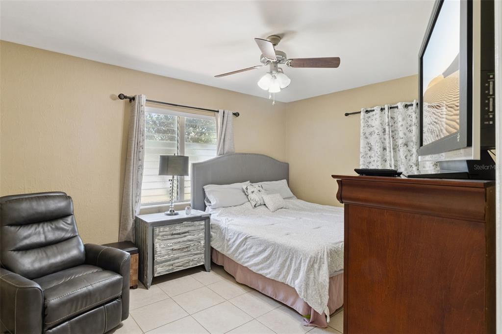 303 Granada Road Auburndale, FL 33823 - Photo 9 of 25 a bedroom with a bed couch and window