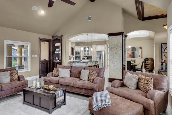a open kitchen with stainless steel appliances granite countertop a stove a sink a oven a dining table and chairs