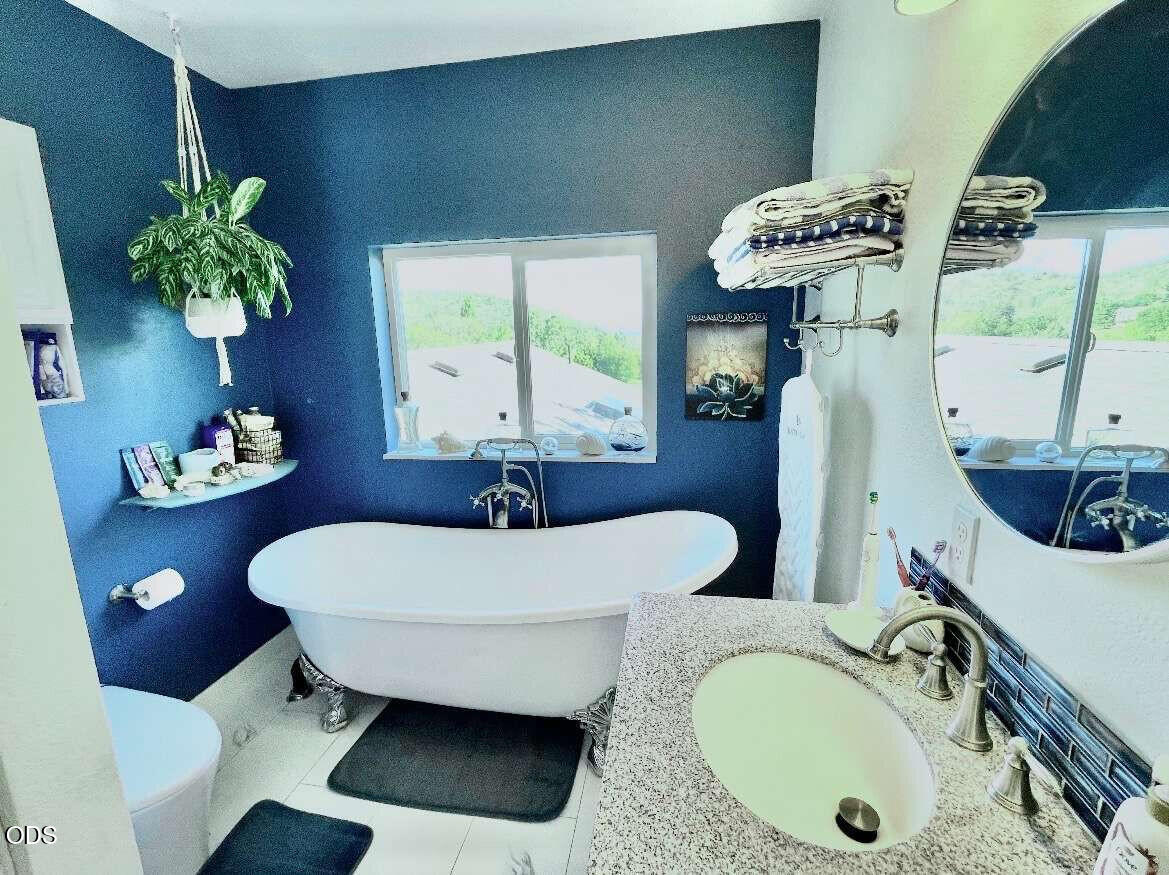 6085 Adams Road Talent, OR 97540 - Photo 19 of 40 a bathroom with a sink mirror and vanity