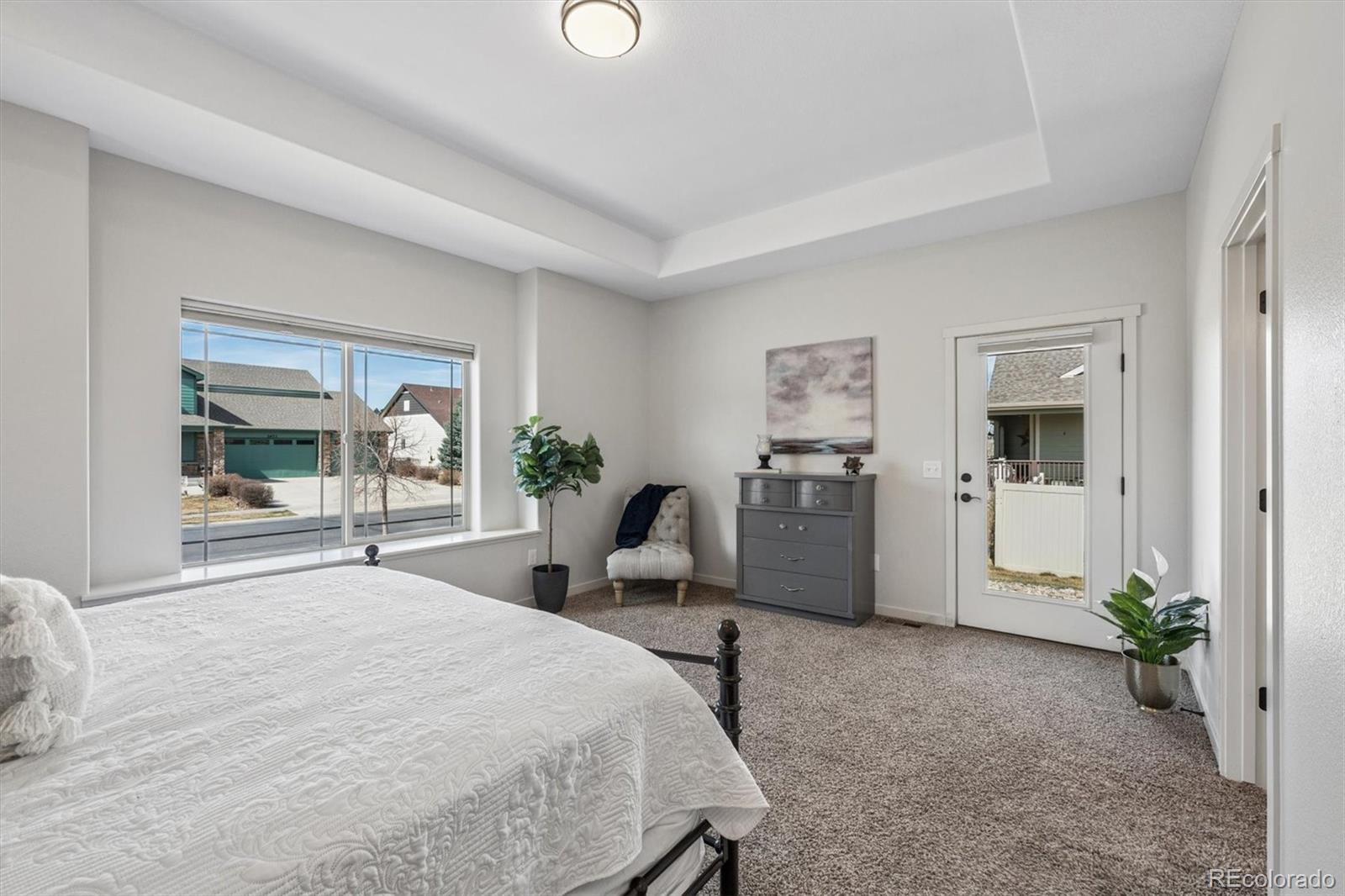 3674 Watts Street Timnath, CO 80547 - Photo 14 of 50 a bedroom with a bed and large windows