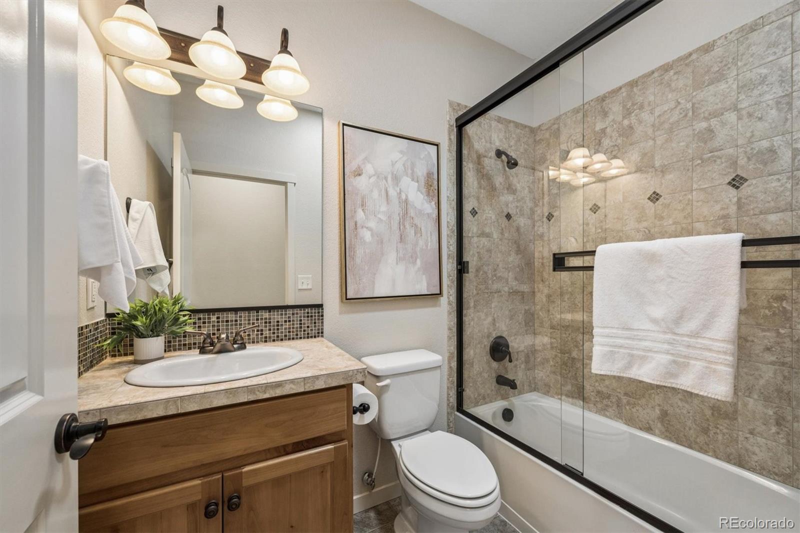 3674 Watts Street Timnath, CO 80547 - Photo 19 of 50 a bathroom with a sink a toilet and shower
