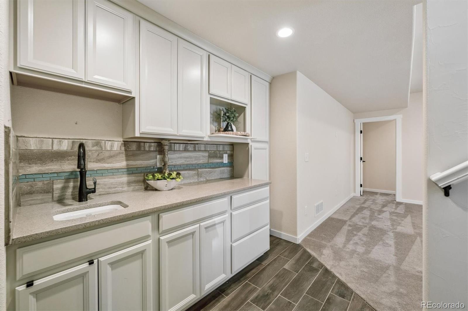 3674 Watts Street Timnath, CO 80547 - Photo 20 of 50 a kitchen with stainless steel appliances granite countertop a sink and cabinets