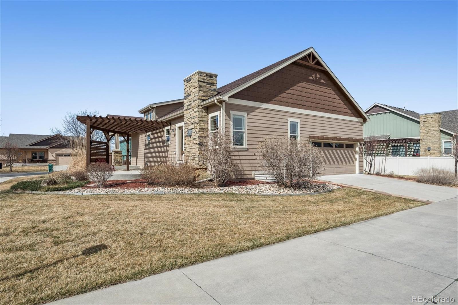 3674 Watts Street Timnath, CO 80547 - Photo 27 of 50 a front view of a house with garden
